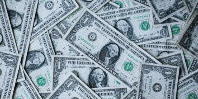 dollar bills piled up