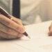 person signing employment contract