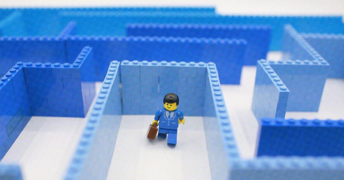 lego businessman going through maze