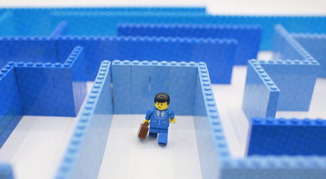 lego businessman going through maze