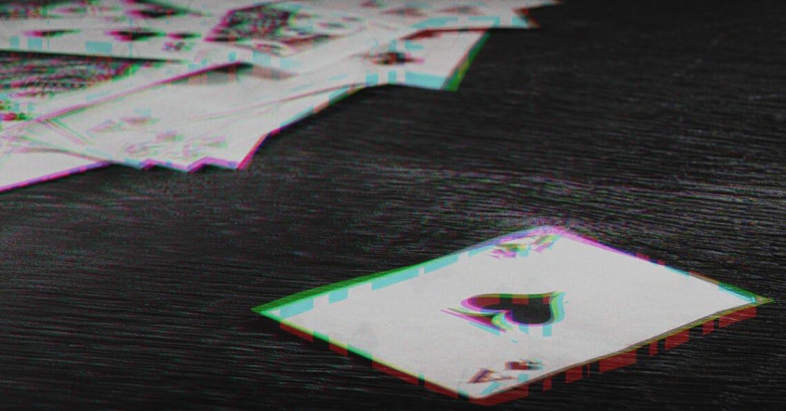 glitchy image of playing cards on table