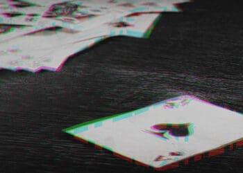 glitchy image of playing cards on table