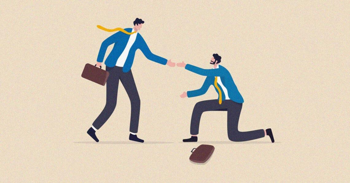 person helping coworker off ground