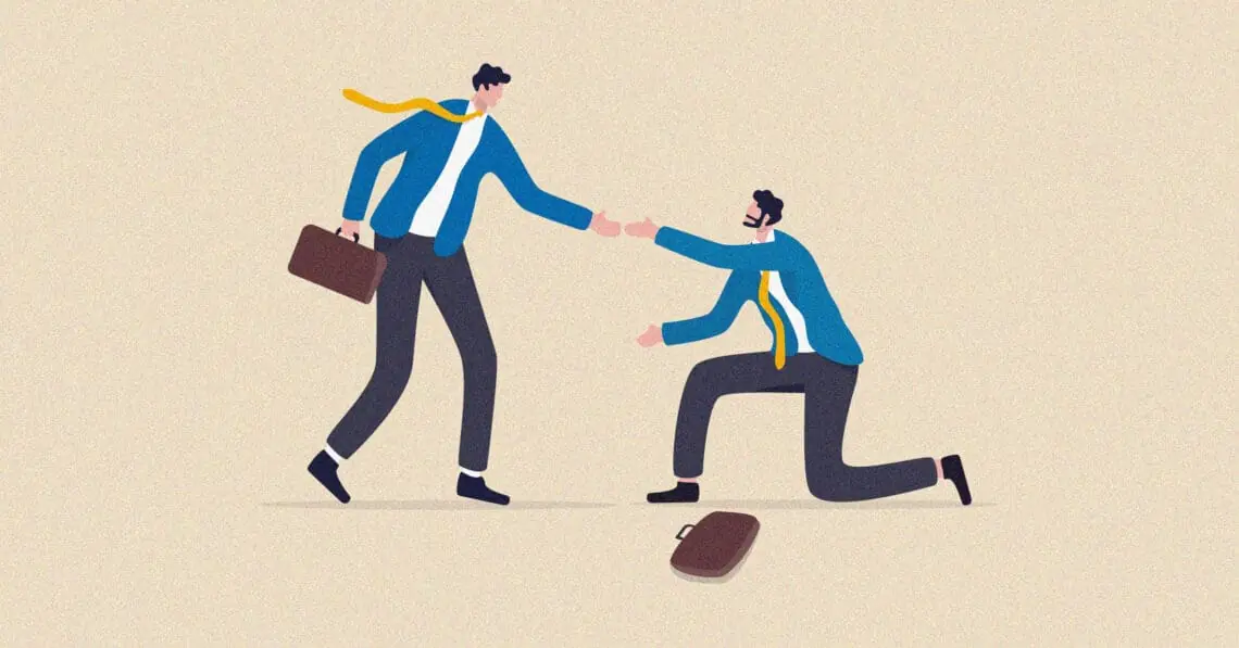 person helping coworker off ground