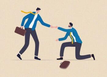 person helping coworker off ground