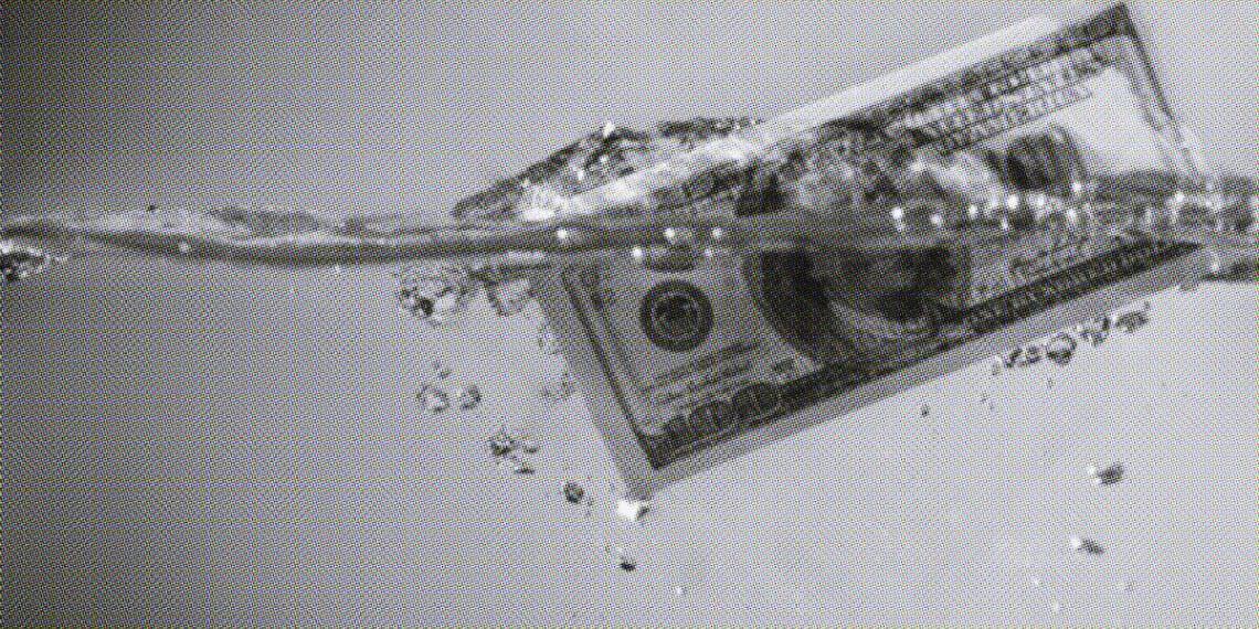 hundred dollar bill floating in water