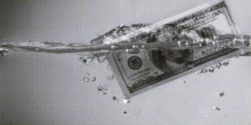 hundred dollar bill floating in water