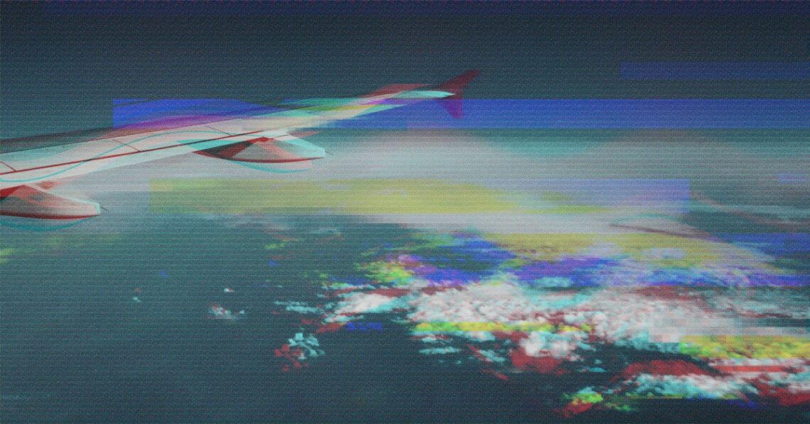 glitchy image of airplane wing mid-flight