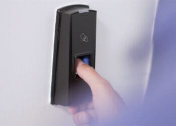 worker using thumbprint machine at door