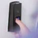 worker using thumbprint machine at door