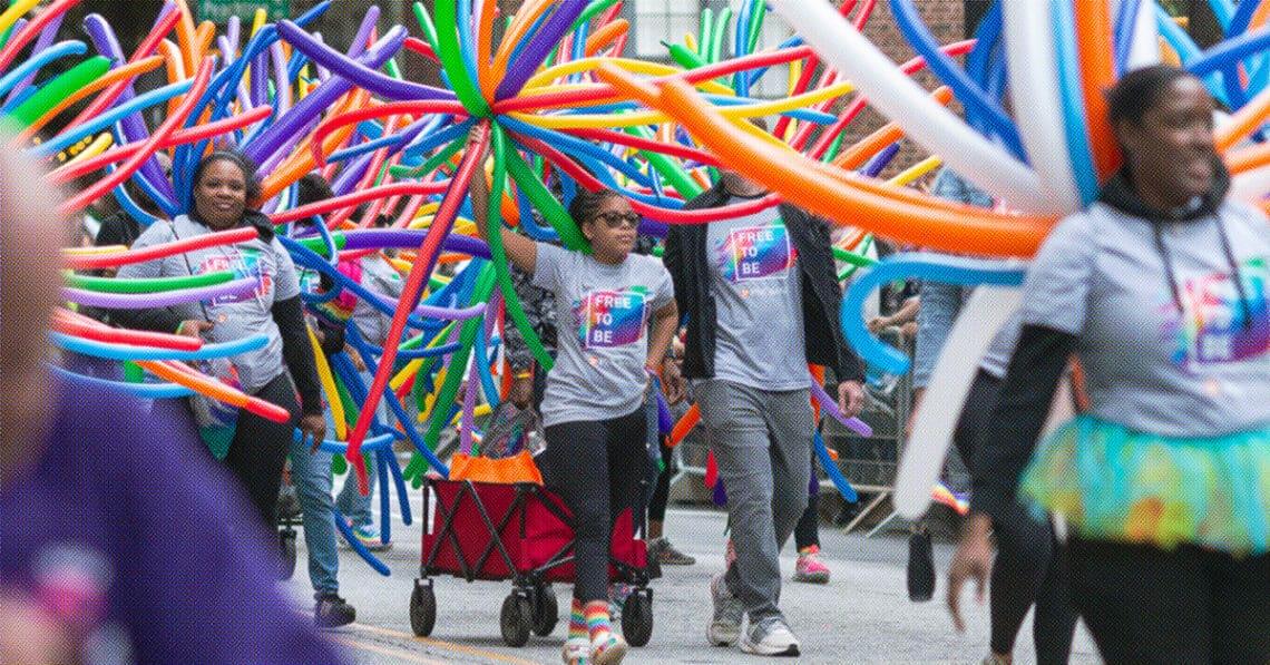 family marching in lgbtq pride parade