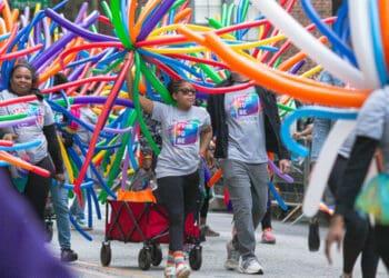 family marching in lgbtq pride parade
