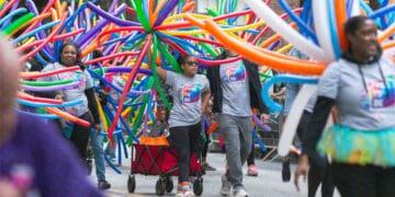 family marching in lgbtq pride parade