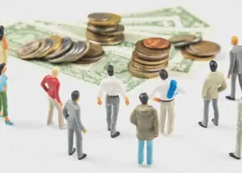 figurines looking at pile of money