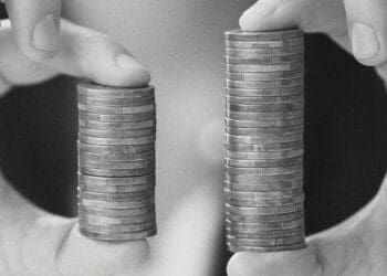 hands with two stacks of coins