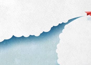 paper airplane cutting through clouds