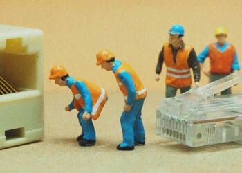 small figurines connecting ethernet cable