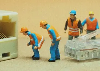 small figurines connecting ethernet cable