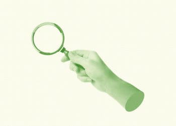 workplace investigation hand holding magnifying glass