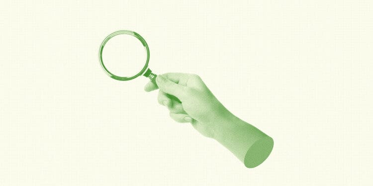 workplace investigation hand holding magnifying glass