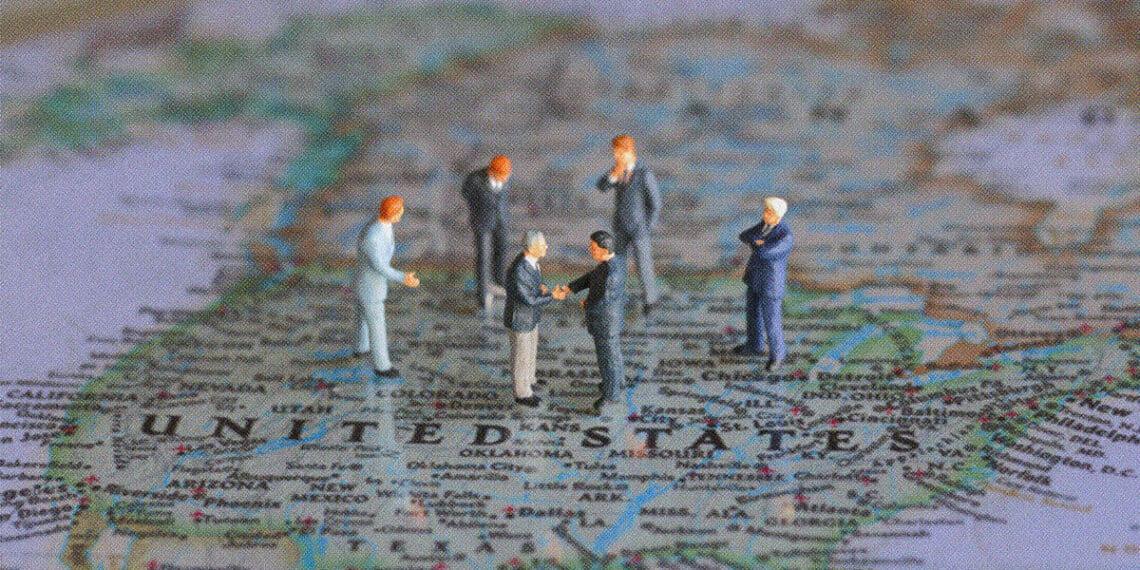 political figurines meeting on top of US map