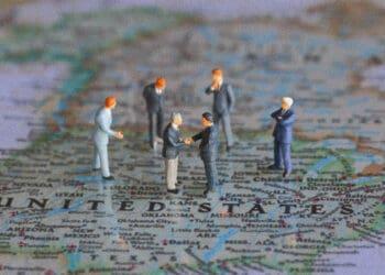 political figurines meeting on top of US map