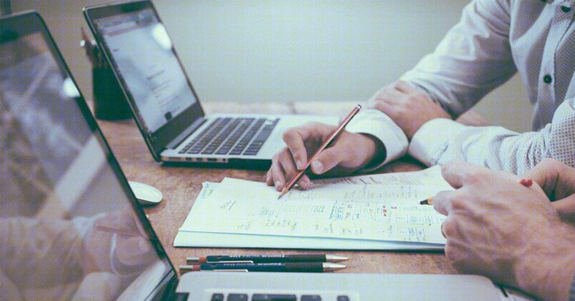 examining data on laptop screen