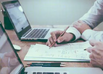 examining data on laptop screen