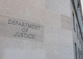 doj building sign with flags