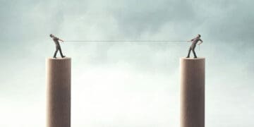 surrealist businessmen on platforms doing tug of war