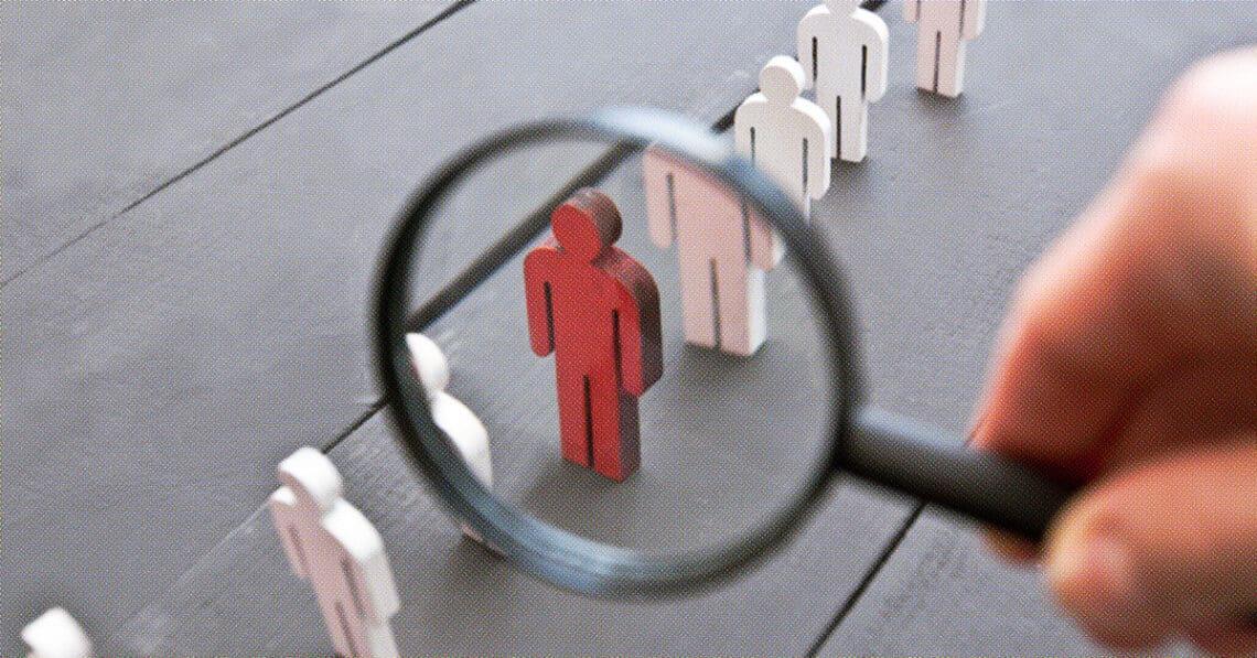 wooden figurines magnifying glass isolating one