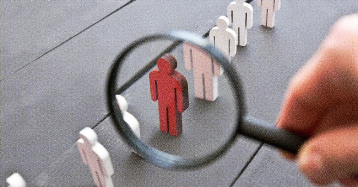 wooden figurines magnifying glass isolating one