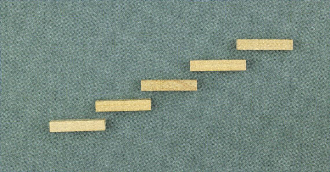 5 wooden steps on a wall
