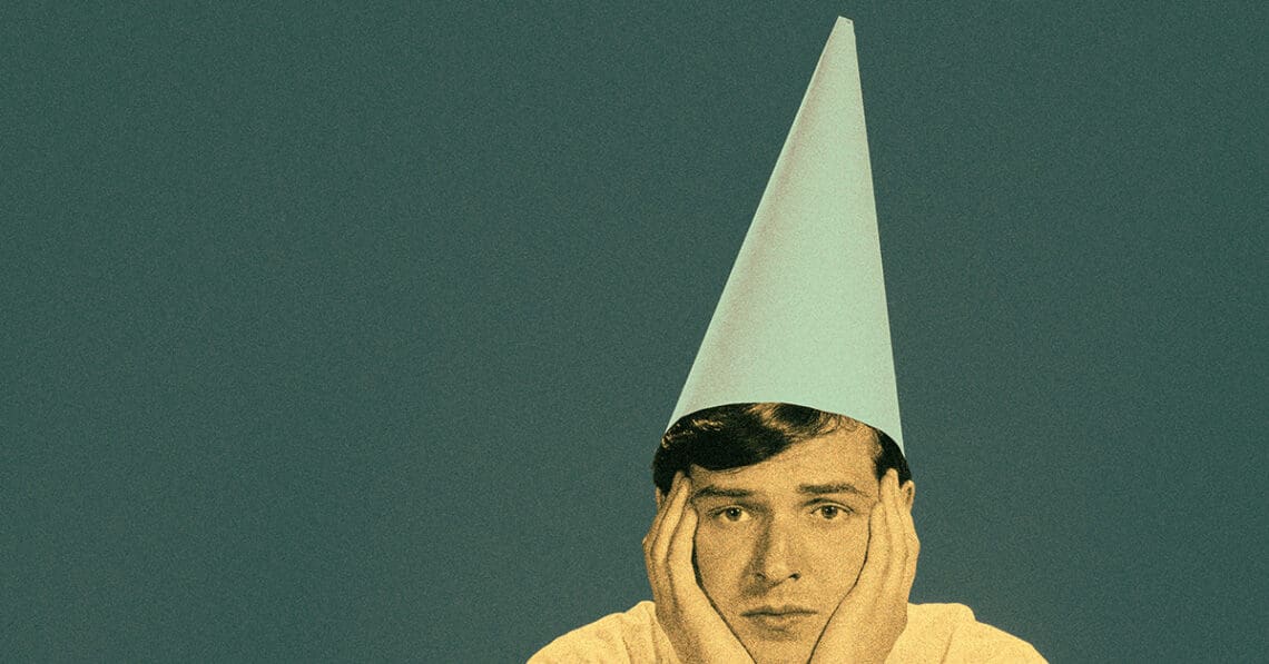 person wearing dunce cap