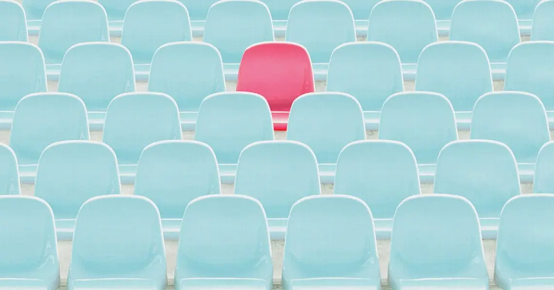 red seat amid blue seats
