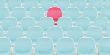 red seat amid blue seats