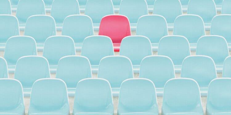 red seat amid blue seats