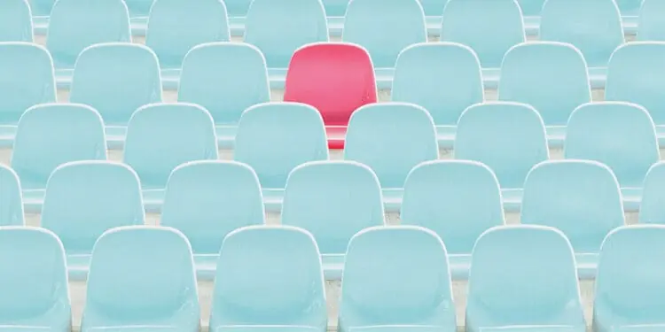 red seat amid blue seats
