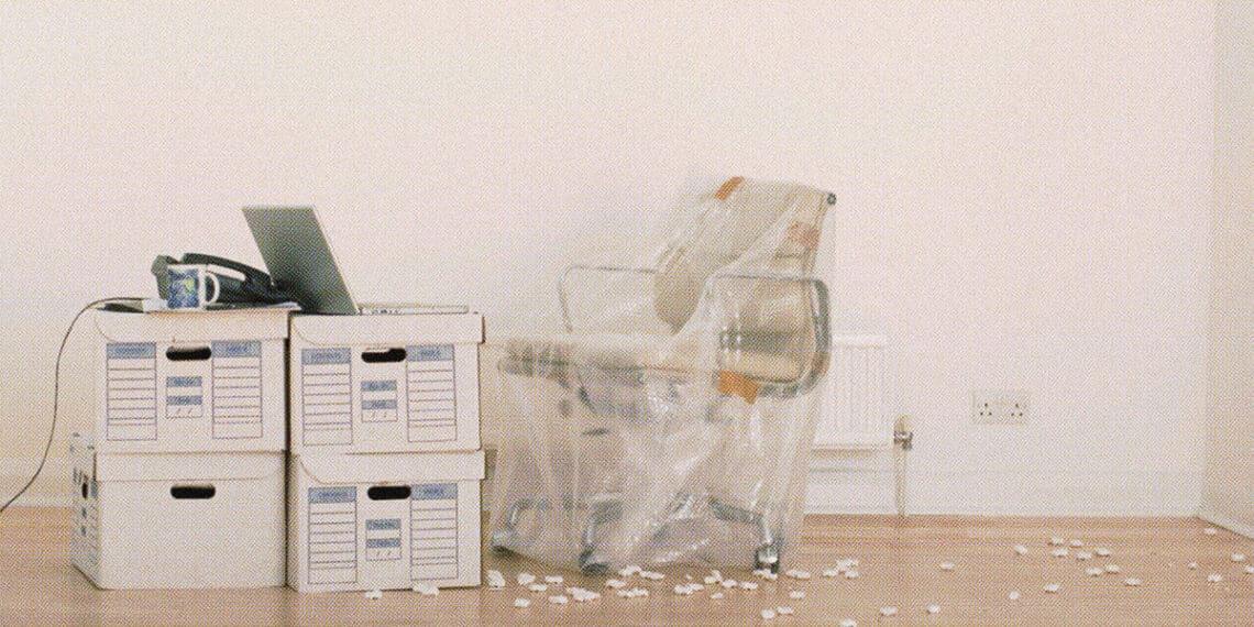 office chair wrapped and boxes on floor