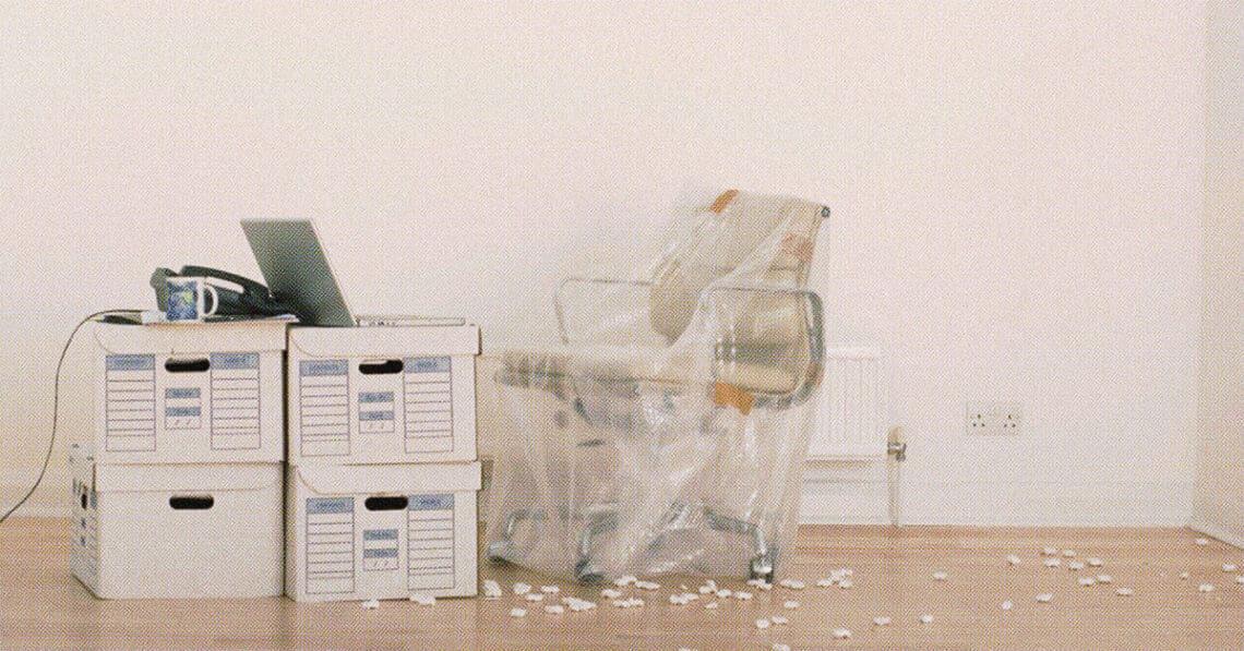 office chair wrapped and boxes on floor
