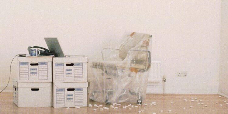 office chair wrapped and boxes on floor