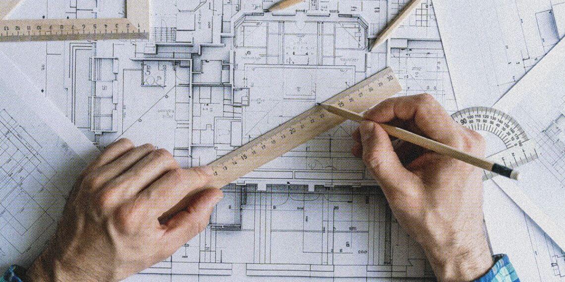 architect drawing on plans