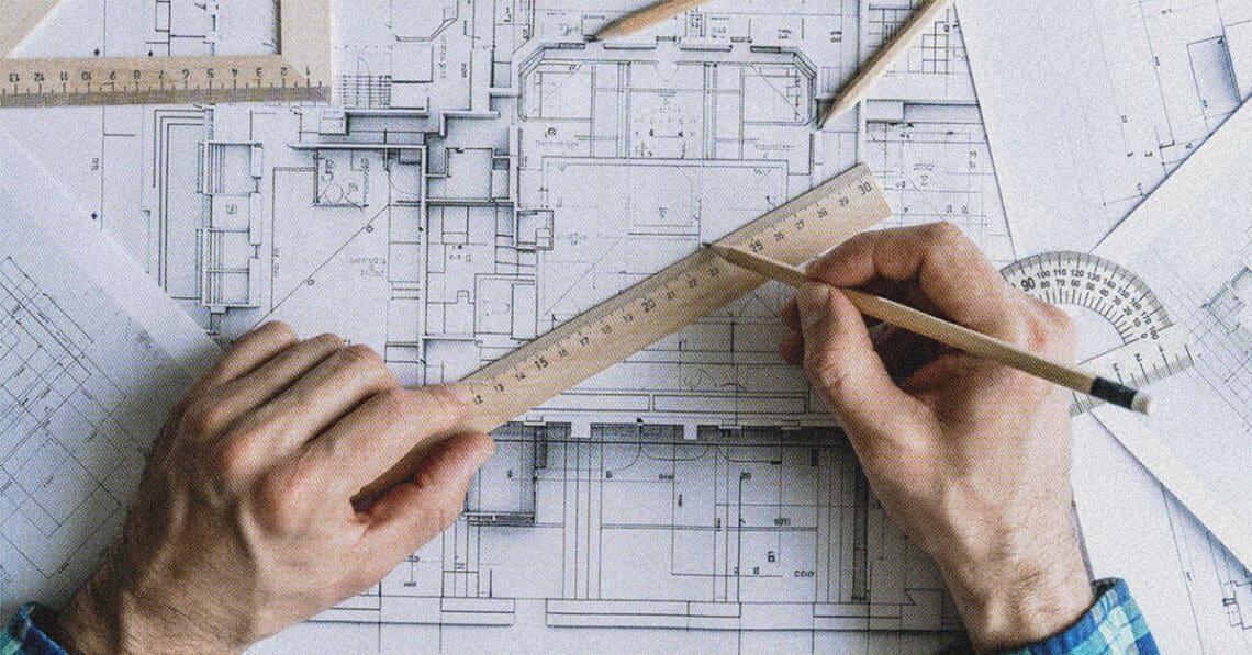 architect drawing on plans