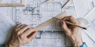 architect drawing on plans