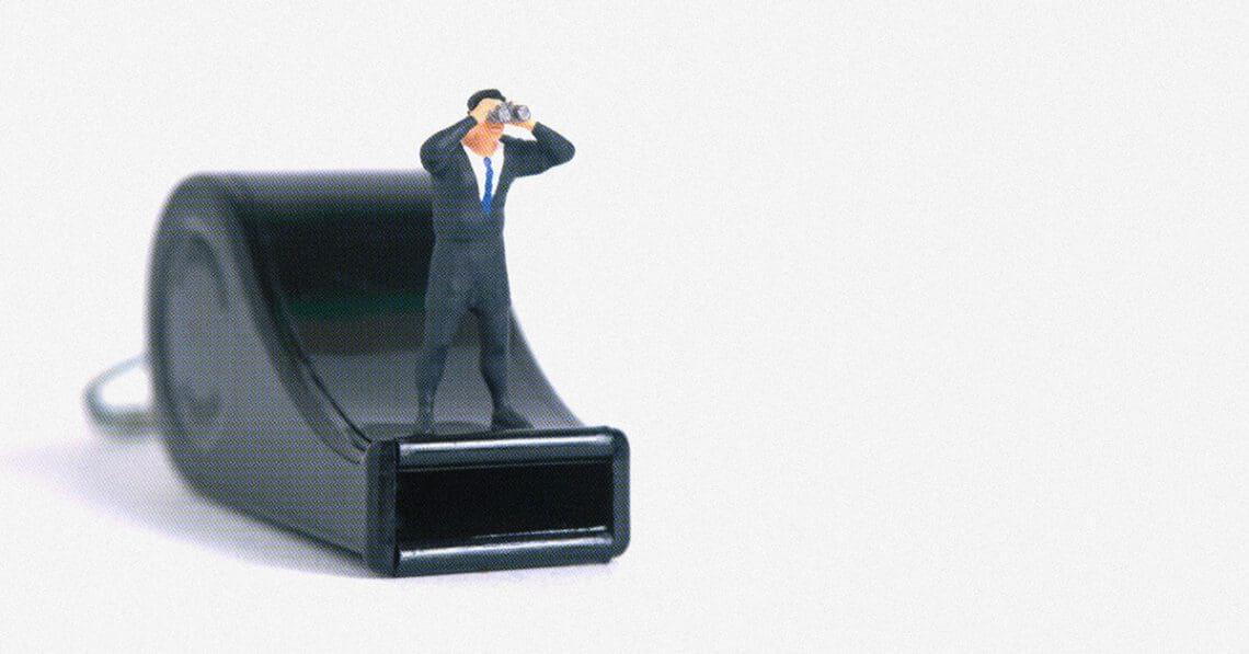 businessman figurine on whistle whistleblowing concept
