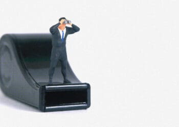 businessman figurine on whistle whistleblowing concept