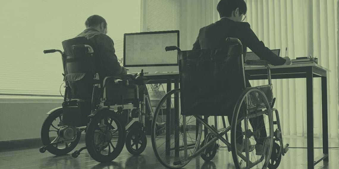 colleagues in wheelchairs at desk