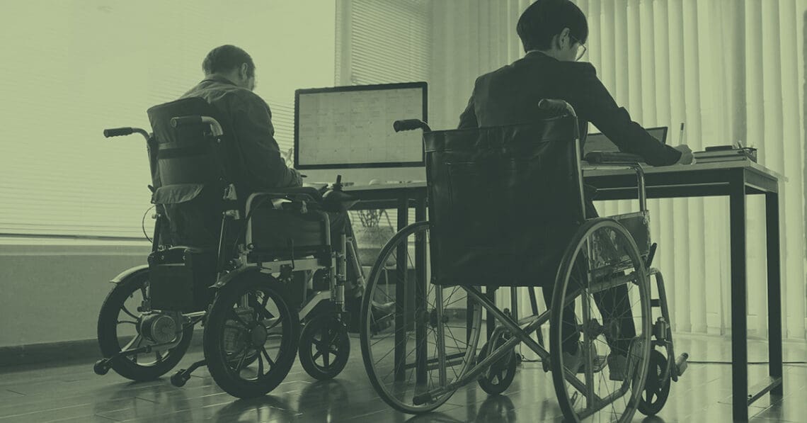 colleagues in wheelchairs at desk