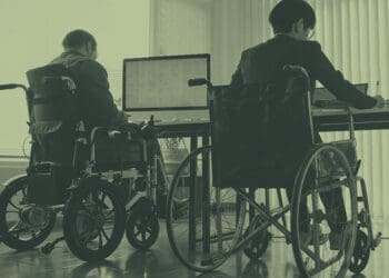 colleagues in wheelchairs at desk