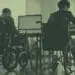 colleagues in wheelchairs at desk